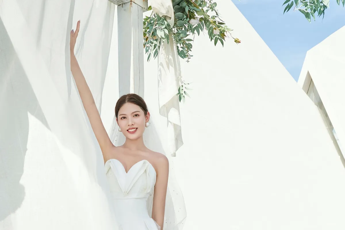 Jeune femme élégante en robe blanche dans un environnement luxueux